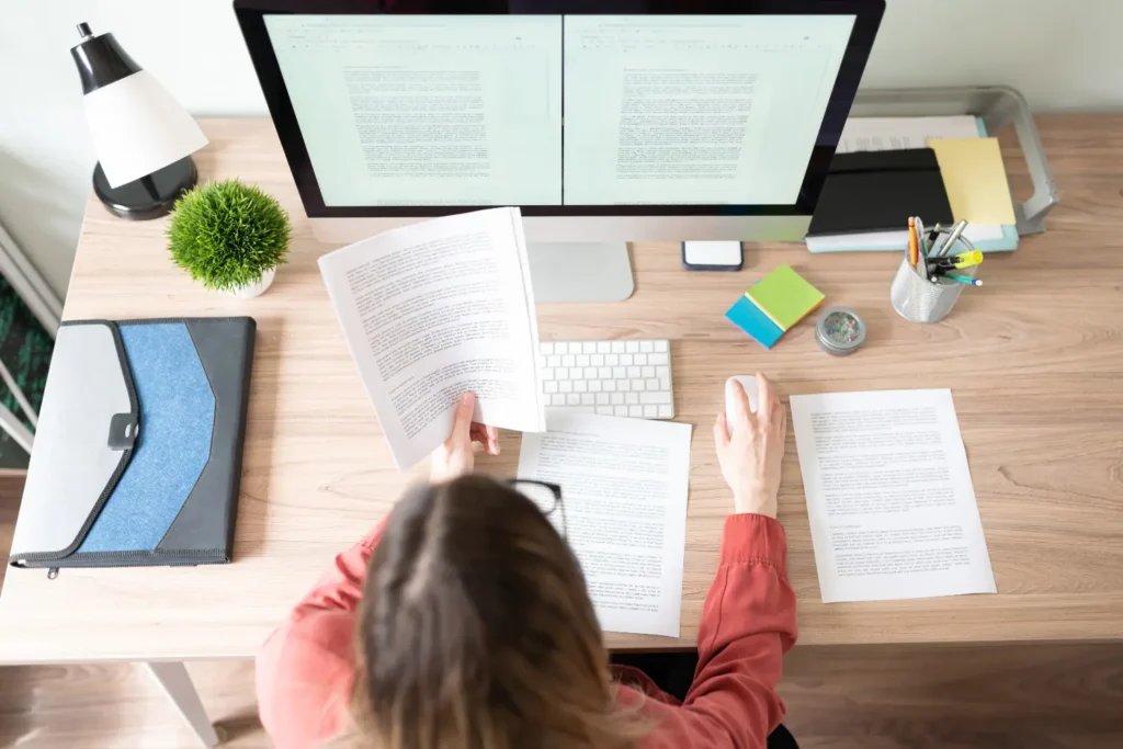 a copywriter on her computer typing up a document - digitech