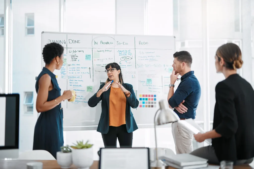 marketing specialists in a conference room discussing strategies - Digitech